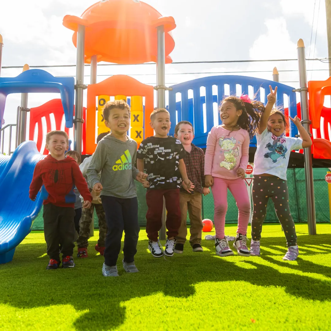 Children standing beside playground equipment