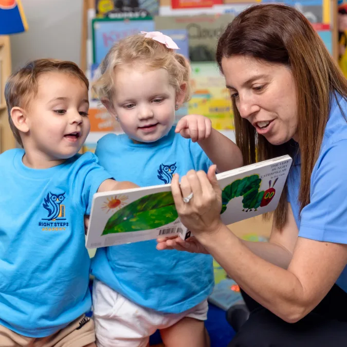 Teacher reading a picture book with children