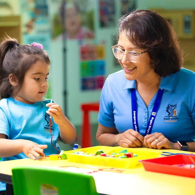 Teacher helping children with a classroom activity