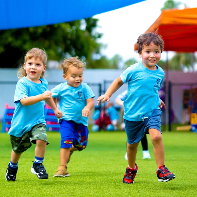 Children running together in the outdoor play area