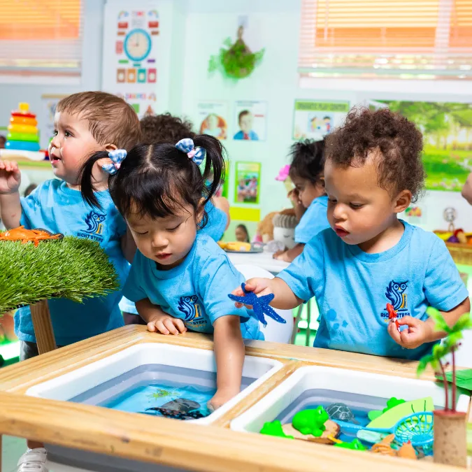 Children exploring a classroom activity table